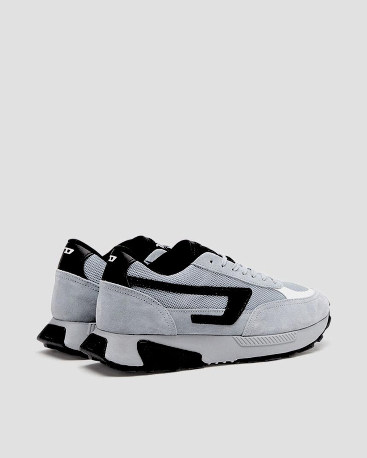 Gray and black sneakers on a light gray background