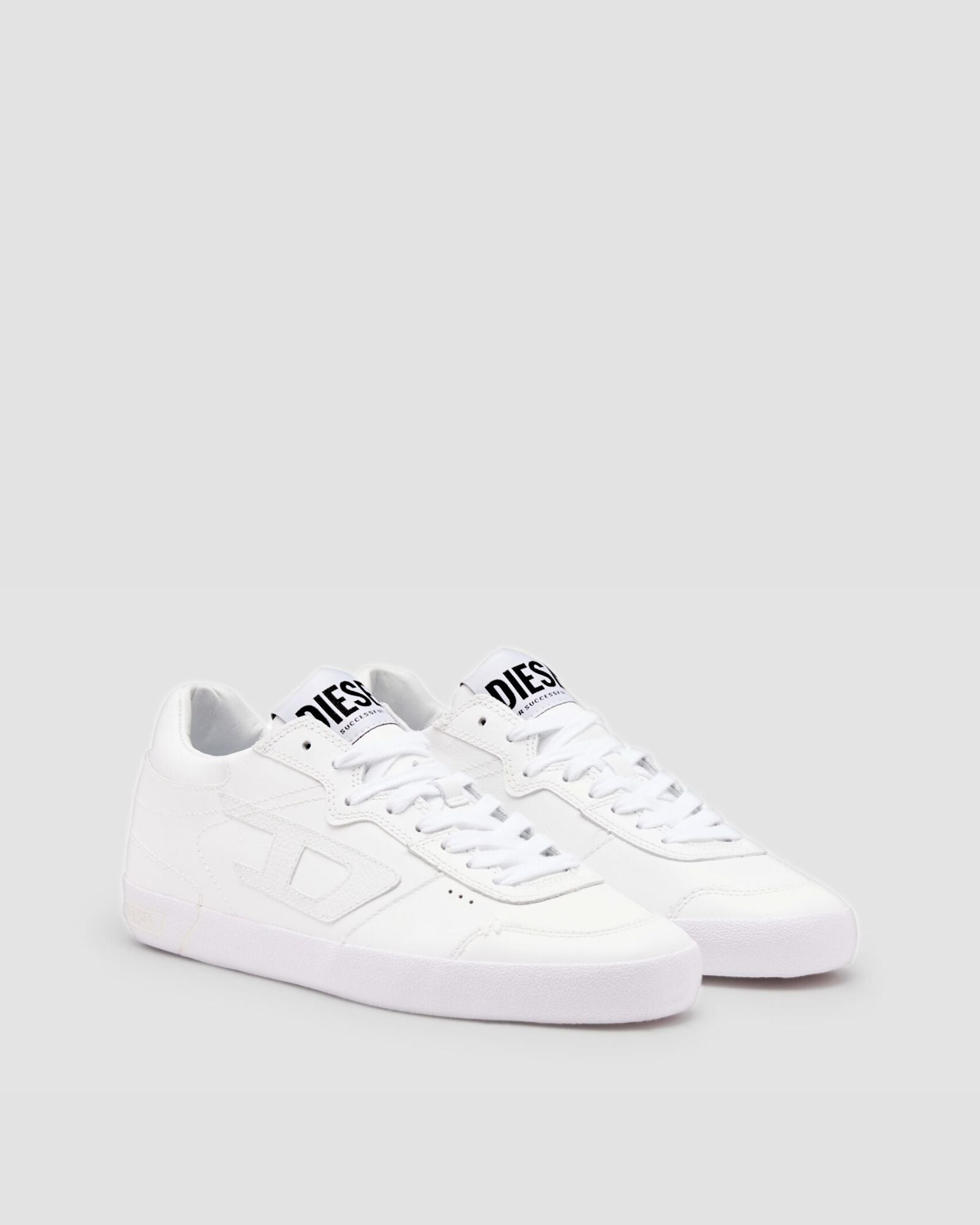 White sneaker with black logo on a light gray background