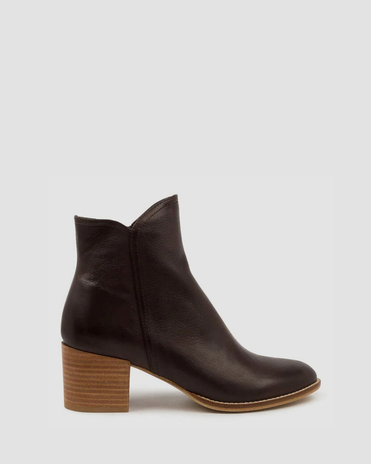 Brown ankle boot with a wooden heel on a light gray background