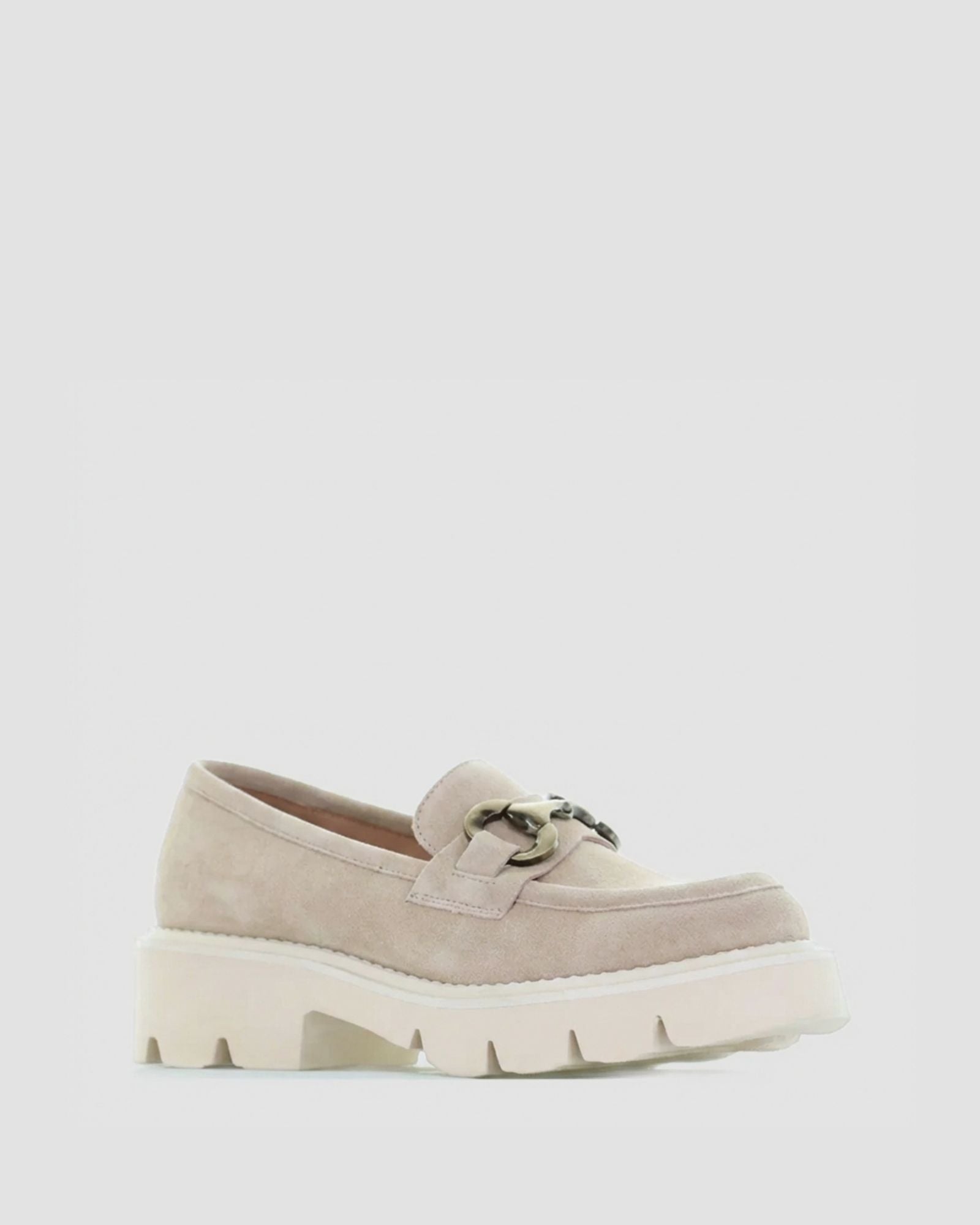 Beige loafers with chunky white sole on a light gray background