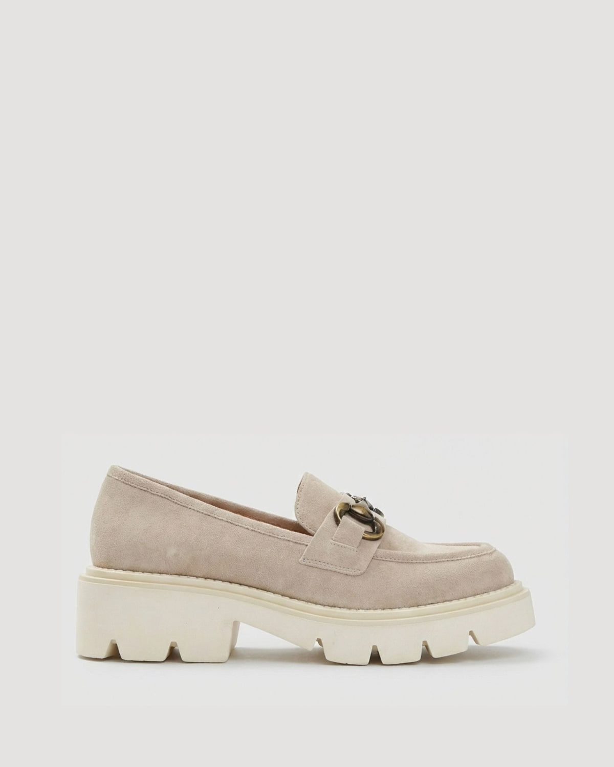 Beige loafers with chunky white sole on a light gray background
