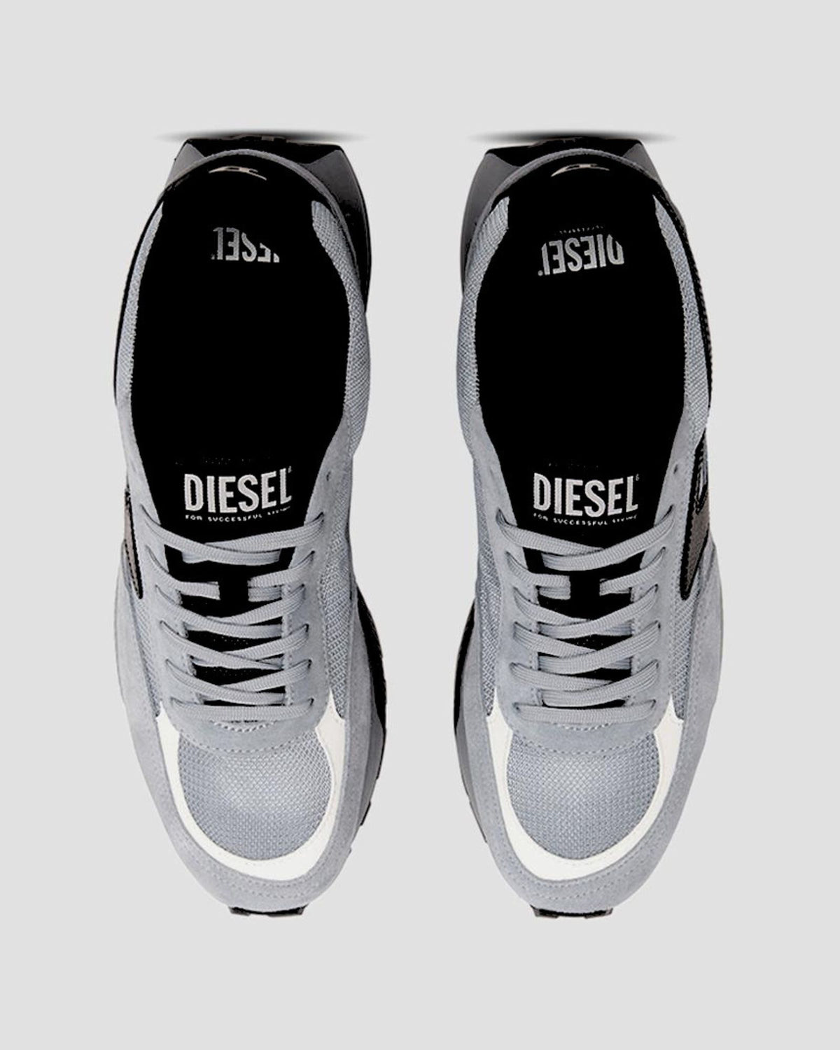 Pair of gray sneakers with 'Diesel' branding on a light gray background